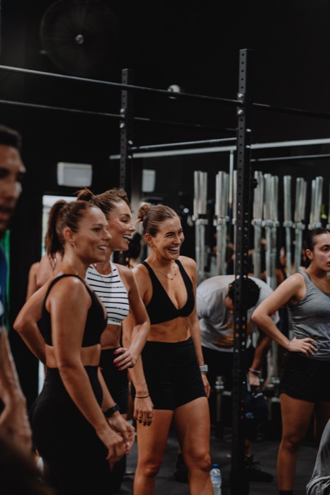 Members sharing a joke on the gym floor