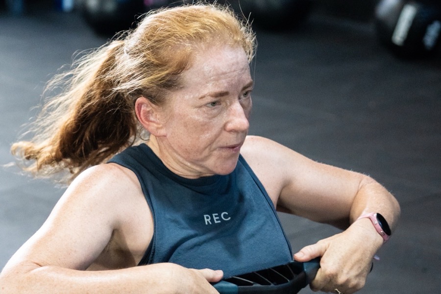 A member working hard on the rower